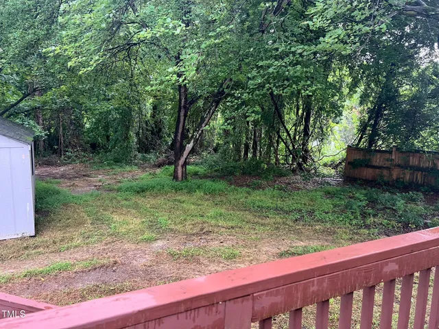 a view of a yard with a tree
