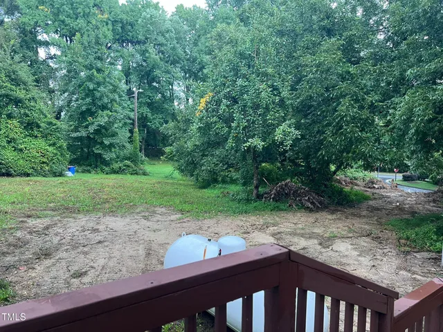 a view of a yard with a wooden fence