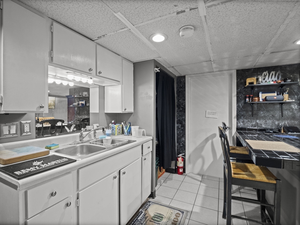 106 Lundberg Street, Unit 6 Lowell, MA 01852 - Photo 23 of 29 a kitchen with a sink stove and cabinets