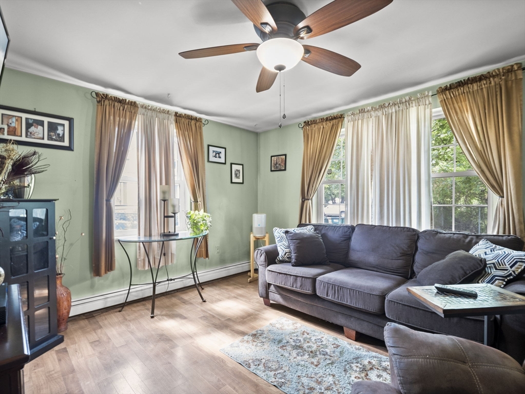 106 Lundberg Street, Unit 6 Lowell, MA 01852 - Photo 5 of 29 a living room with furniture and a large window