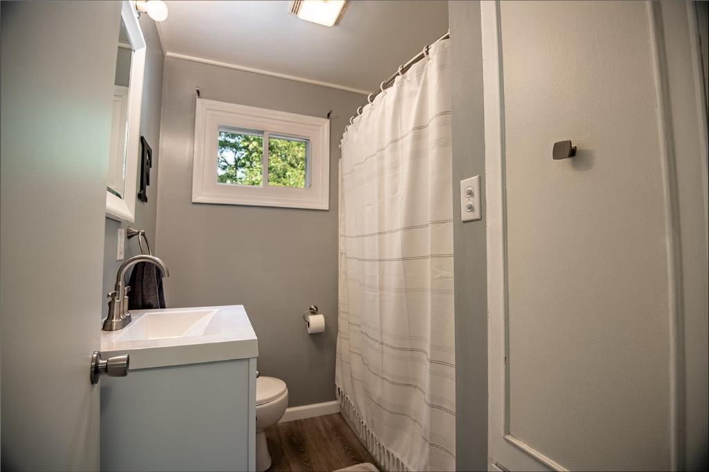 1010 South Keel Ridge Road Hermitage, PA 16148 - Photo 14 of 35 a bathroom with a sink a toilet a window and a mirror