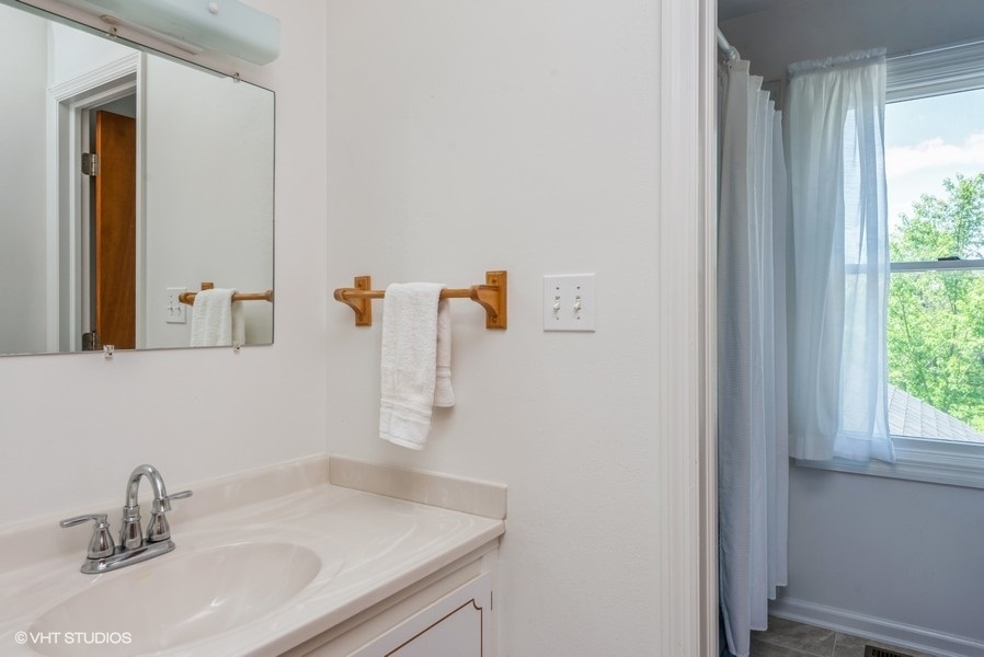 15817 Green Road Harvard, IL 60033 - Photo 14 of 25 a bathroom with a sink and a mirror