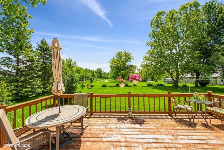 15817 Green Road Harvard, IL 60033 - Photo 17 of 25 a view of a chair and tables on the deck