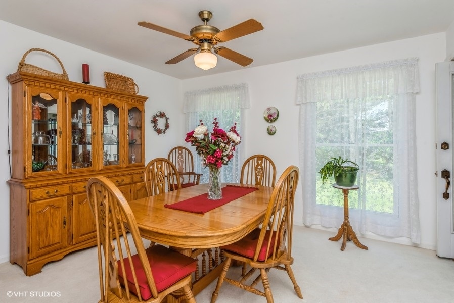 15817 Green Road Harvard, IL 60033 - Photo 6 of 25 a dining room with furniture potted plants and wooden floor