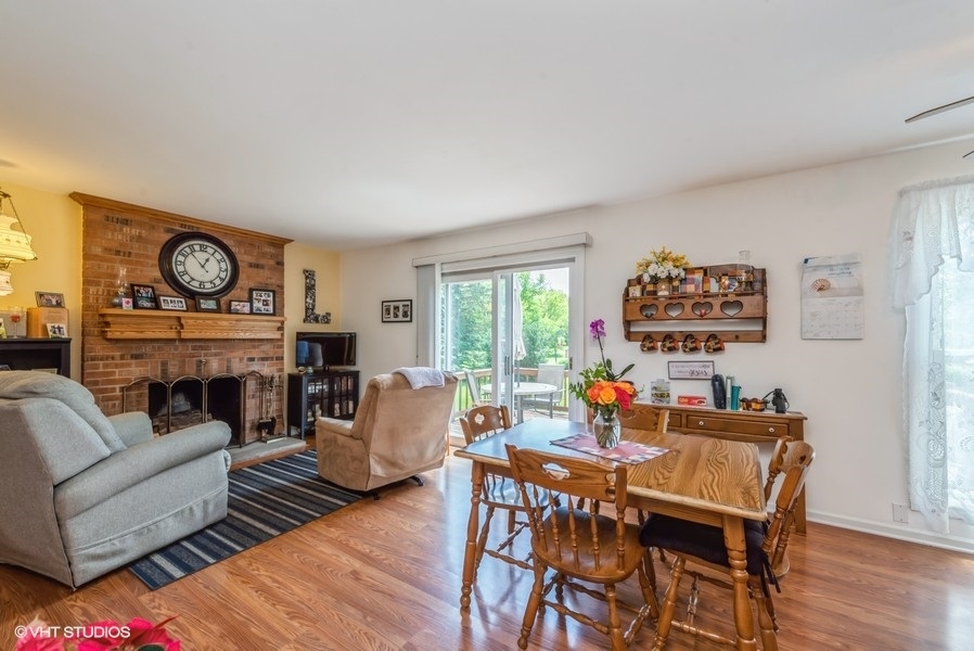 15817 Green Road Harvard, IL 60033 - Photo 7 of 25 a living room with fireplace furniture and a large window