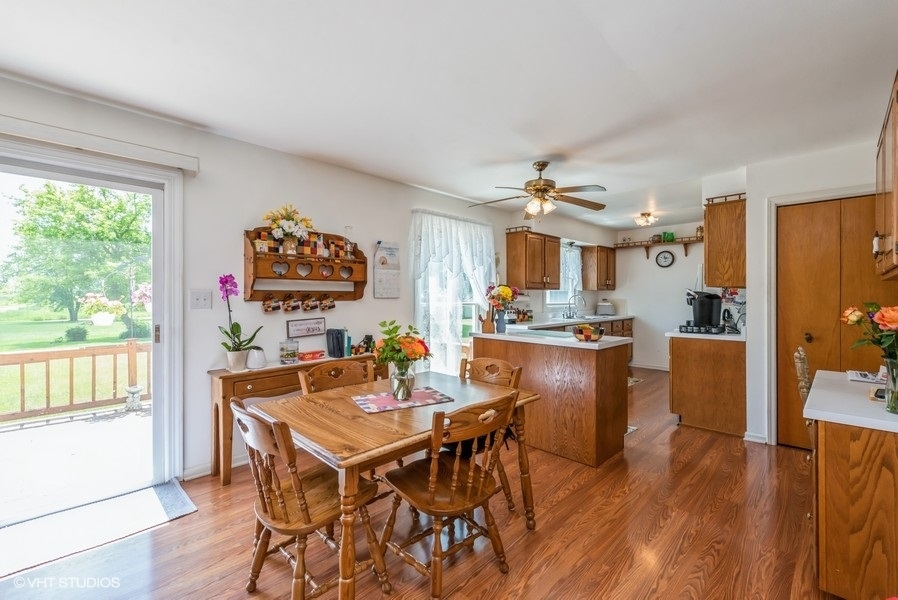 15817 Green Road Harvard, IL 60033 - Photo 8 of 25 a view of a dining room with furniture large window and wooden floor
