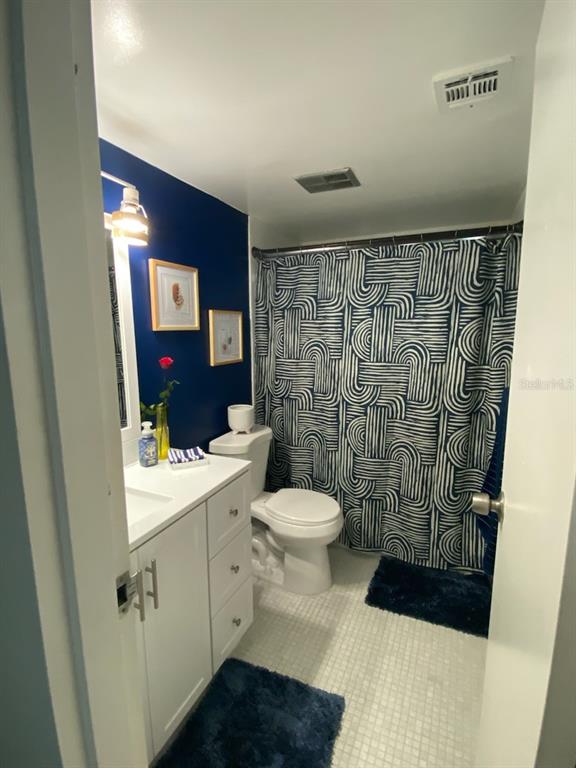 8350 Sands Point Boulevard, Unit 205E Fort Lauderdale, FL 33321 - Photo 13 of 16 a bathroom with a sink and a toilet