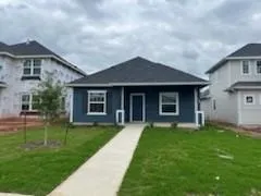 a front view of a house with a garden and yard