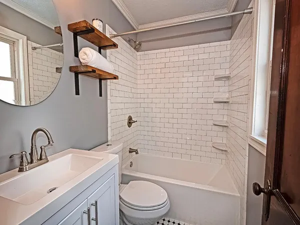a bathroom with a sink toilet and shower