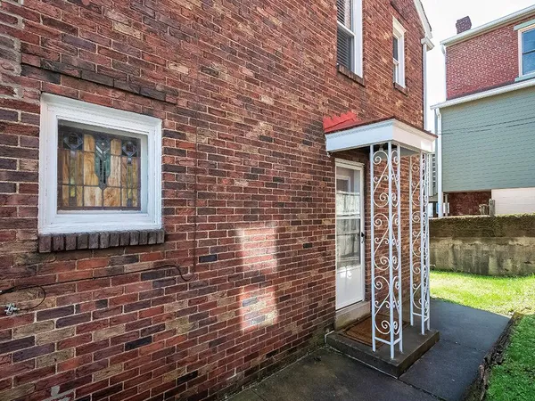 a view of a brick house with a yard