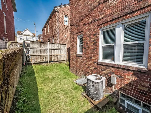a view of a backyard with plants and deck