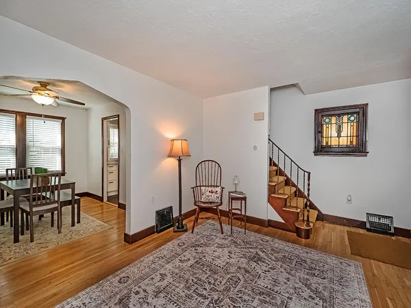 a living room with furniture a rug and a window