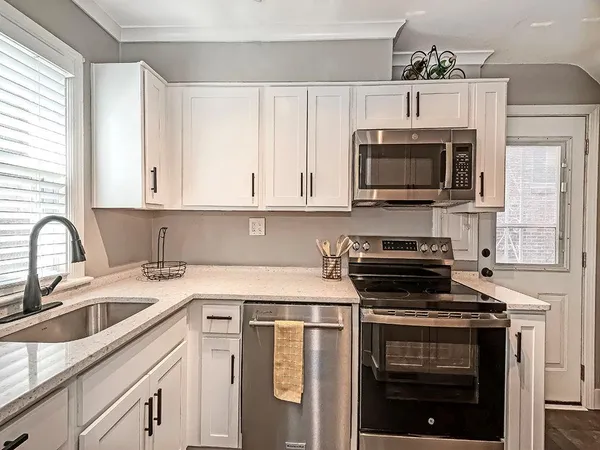 a kitchen with cabinets stainless steel appliances a sink and a counter space