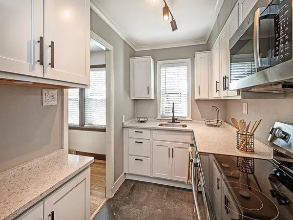 a kitchen that has a sink and a stove