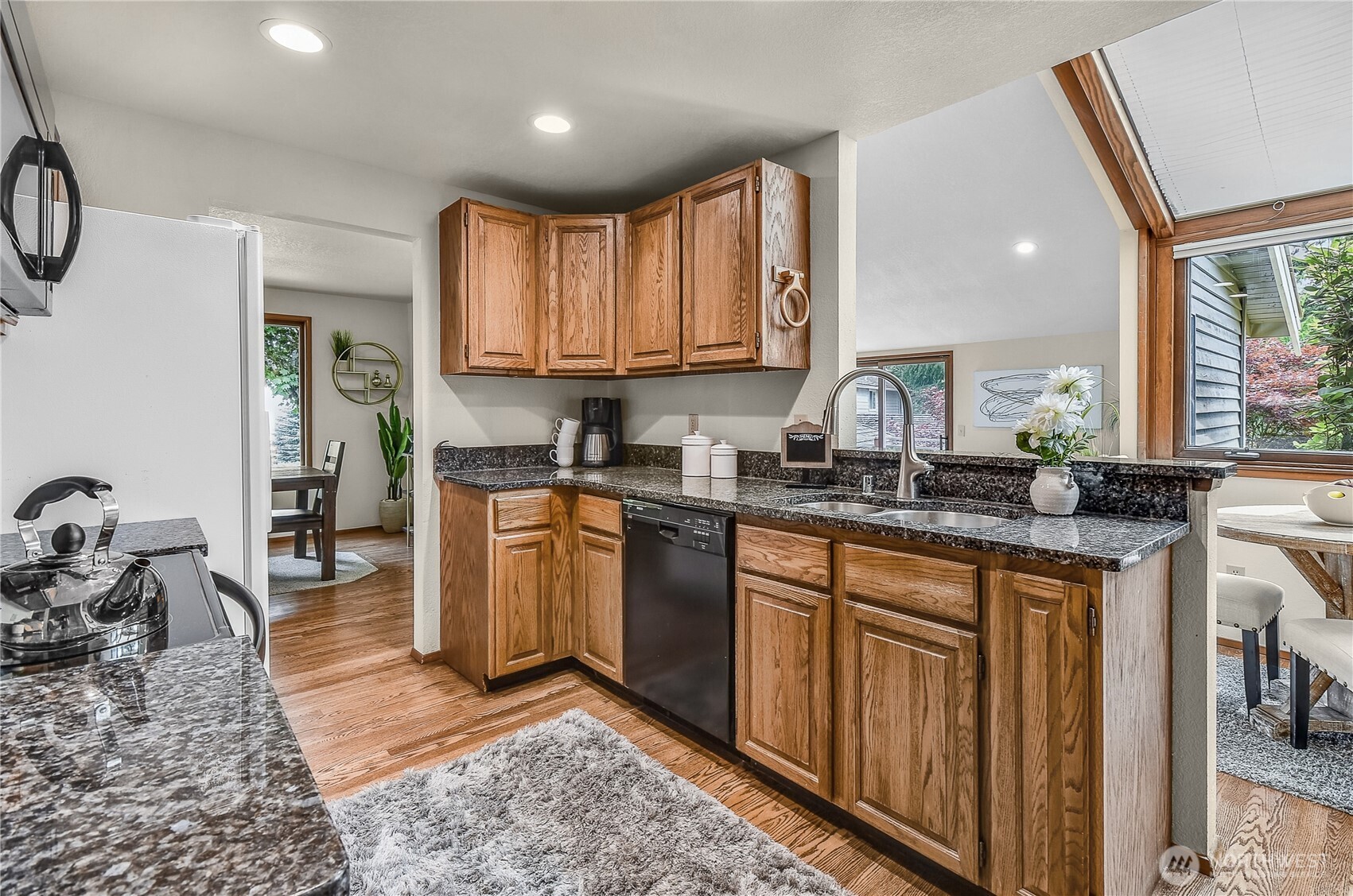 16901 Southeast 45th Street Bellevue, WA 98006 - Photo 13 of 29 a kitchen with granite countertop a stove a sink and a refrigerator