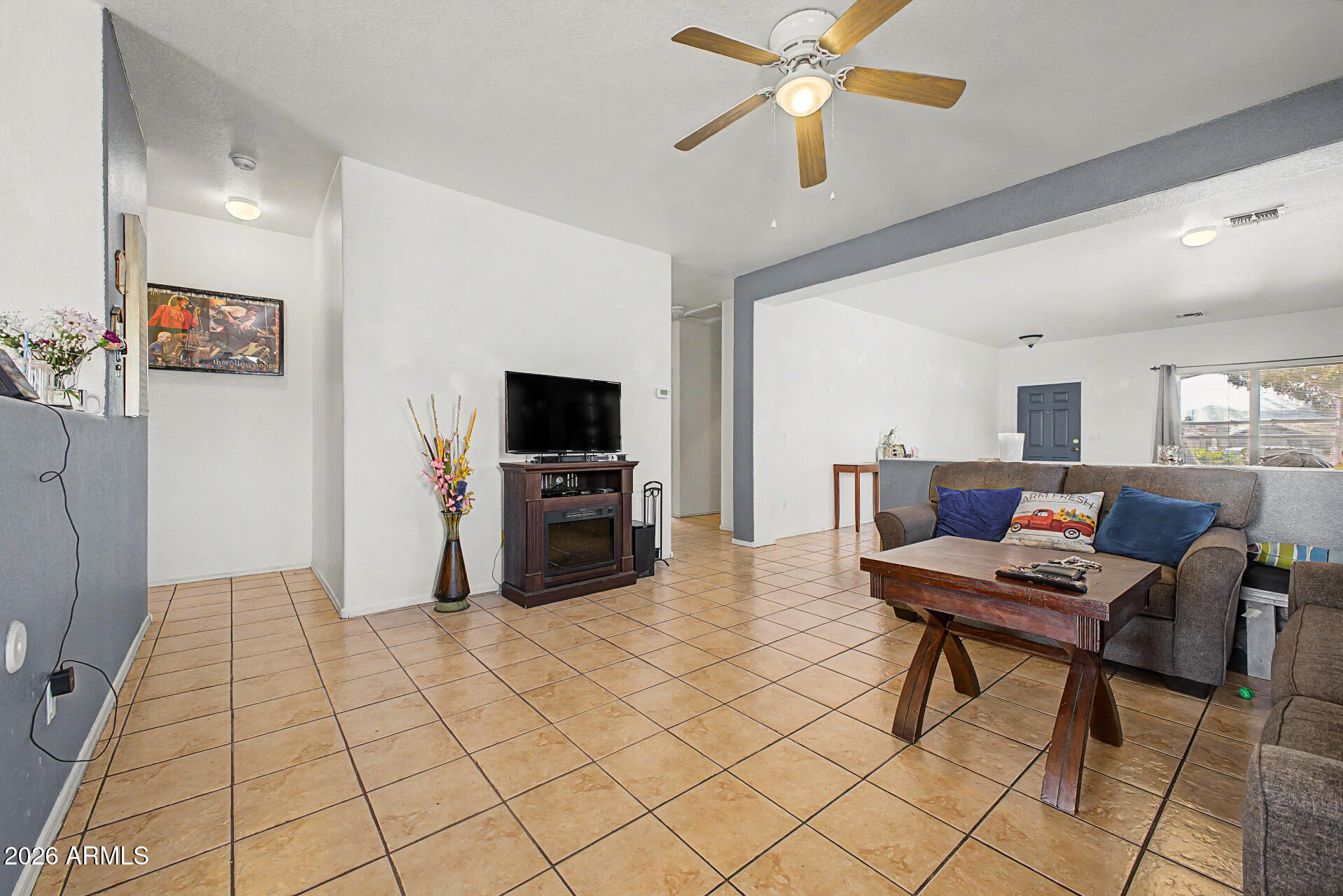 9730 West Payson Road Tolleson, AZ 85353 - Photo 11 of 57 a living room with furniture and a flat screen tv