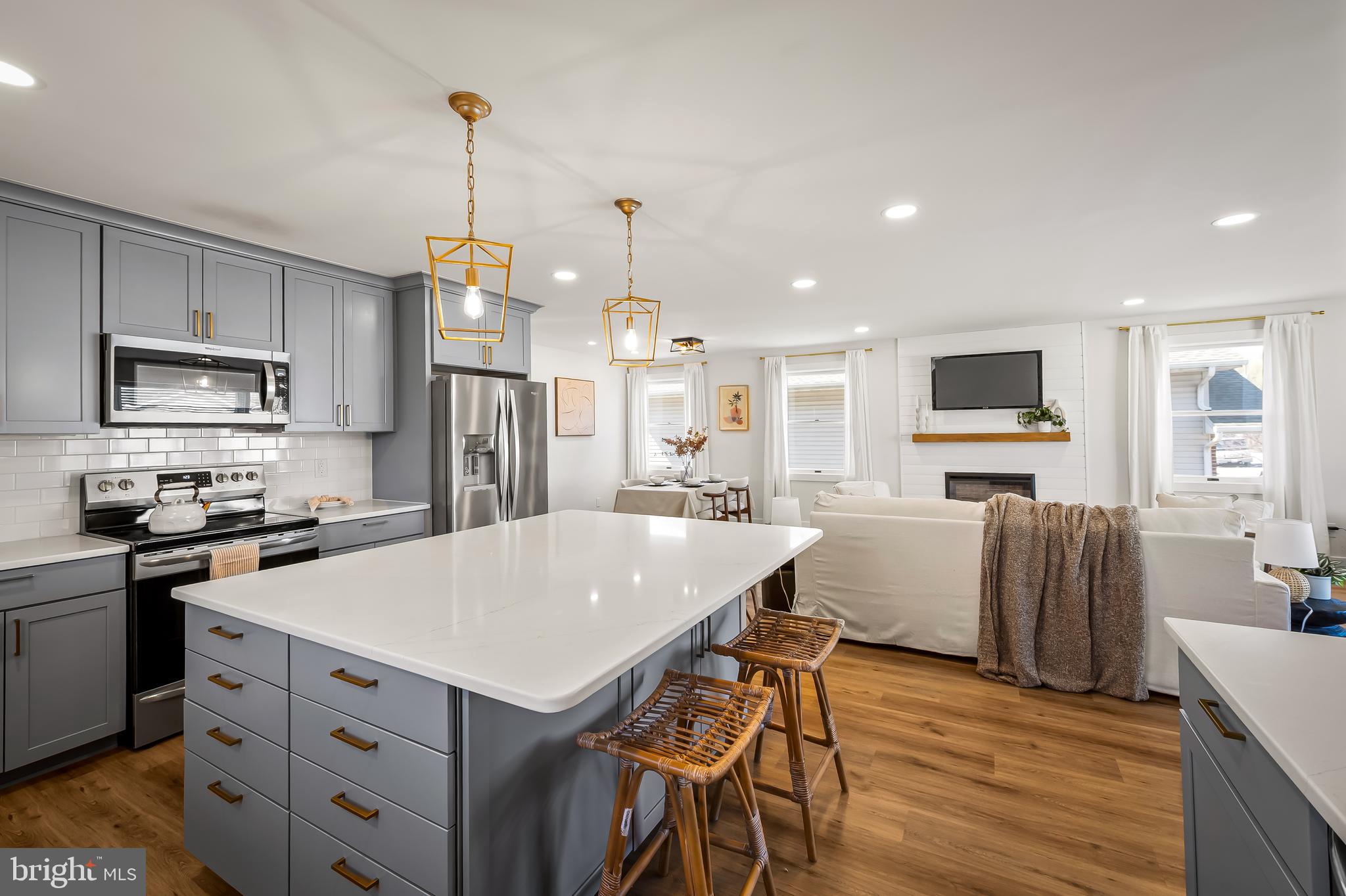 7321 Chesapeake Road Baltimore, MD 21220 - Photo 11 of 60 a kitchen with a refrigerator a stove top oven a sink dishwasher and wooden cabinets with wooden floor
