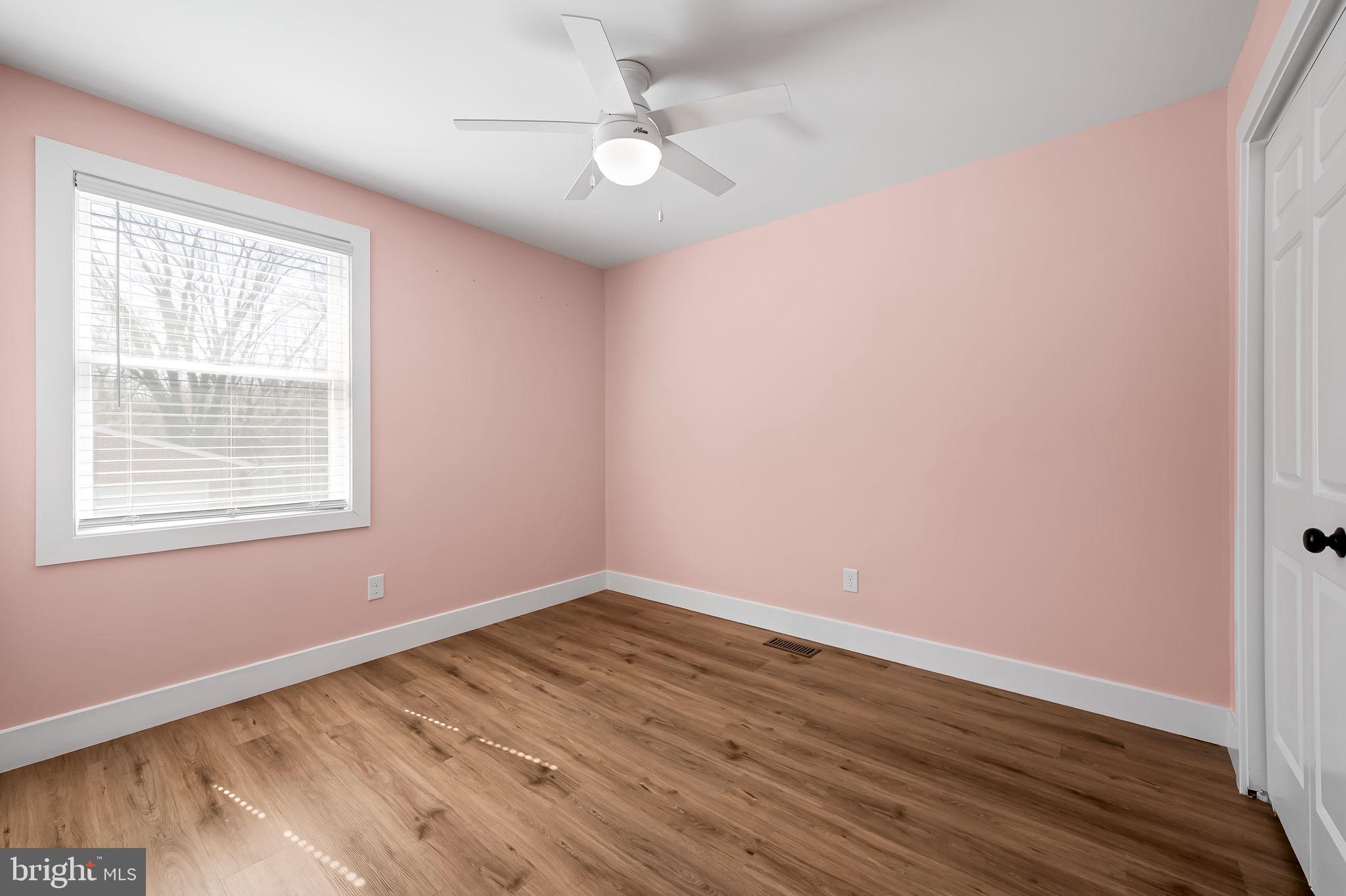 7321 Chesapeake Road Baltimore, MD 21220 - Photo 14 of 60 wooden floor in an empty room with a window