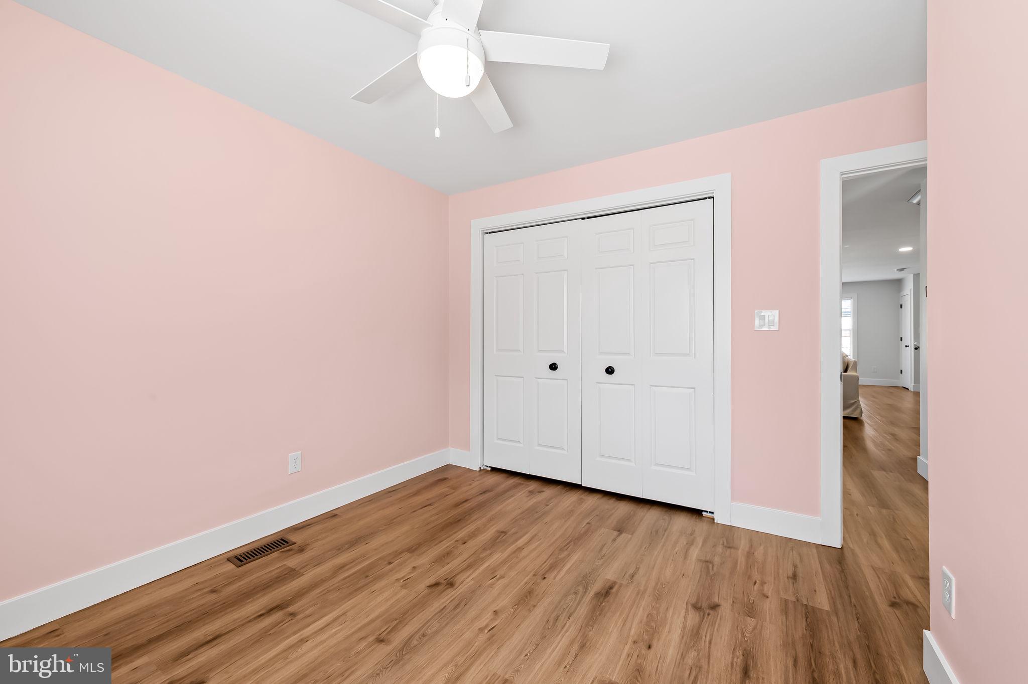 7321 Chesapeake Road Baltimore, MD 21220 - Photo 15 of 60 an empty room with wooden floor and a ceiling fan