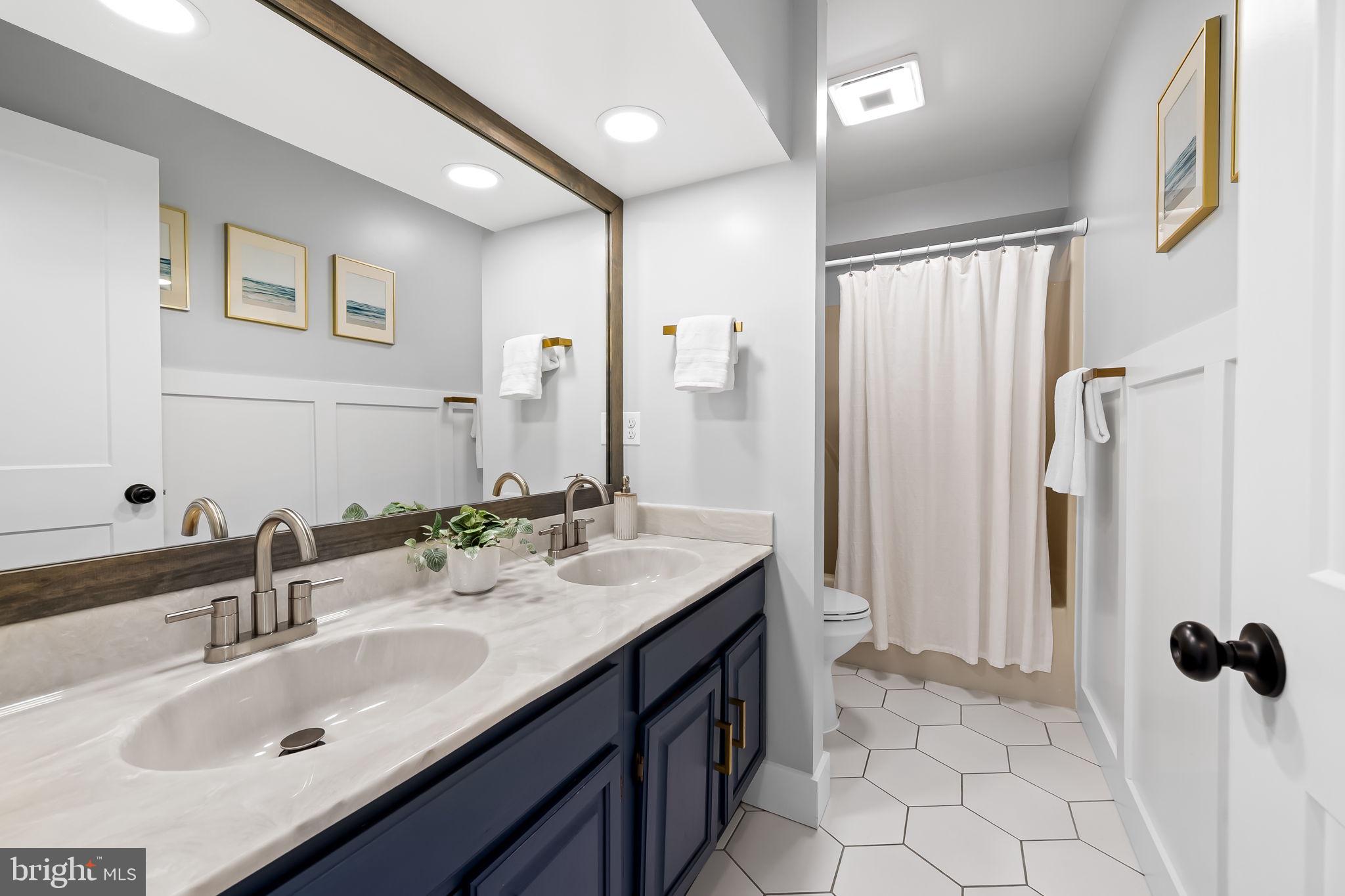 7321 Chesapeake Road Baltimore, MD 21220 - Photo 16 of 60 a bathroom with a sink double vanity and a mirror