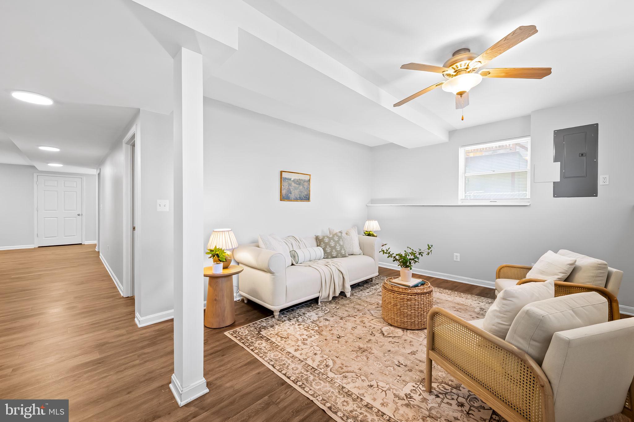7321 Chesapeake Road Baltimore, MD 21220 - Photo 33 of 60 a living room with furniture and a wooden floor