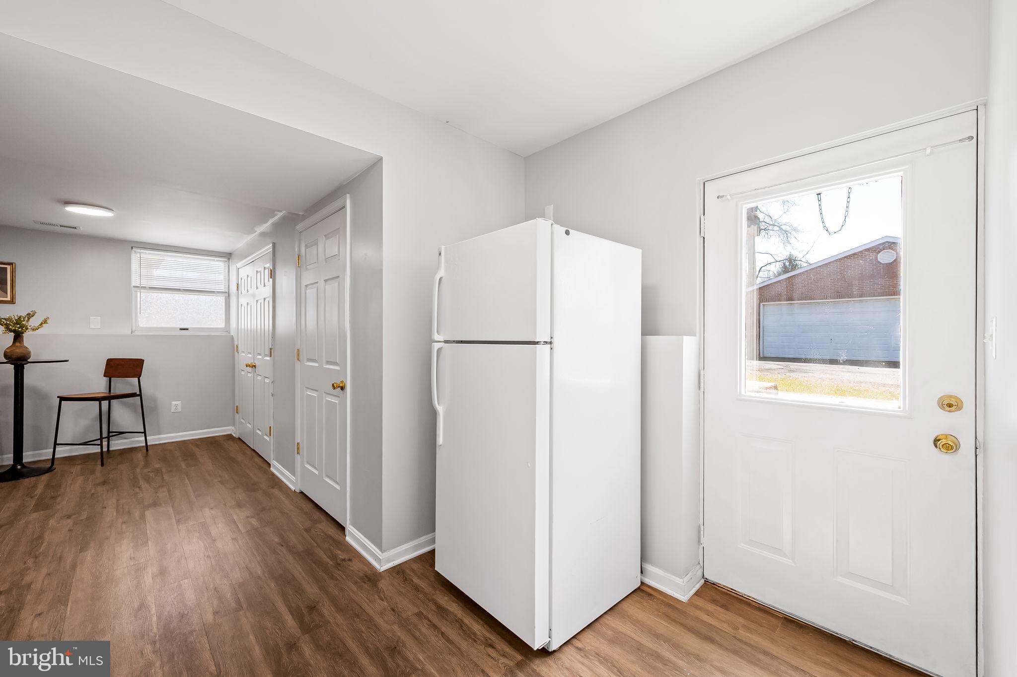 7321 Chesapeake Road Baltimore, MD 21220 - Photo 40 of 60 a view of a kitchen with wooden floor and a refrigerator