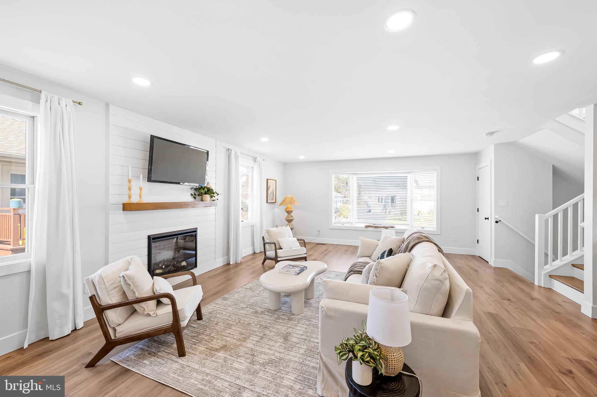 7321 Chesapeake Road Baltimore, MD 21220 - Photo 6 of 60 a living room with furniture a fireplace and a flat screen tv