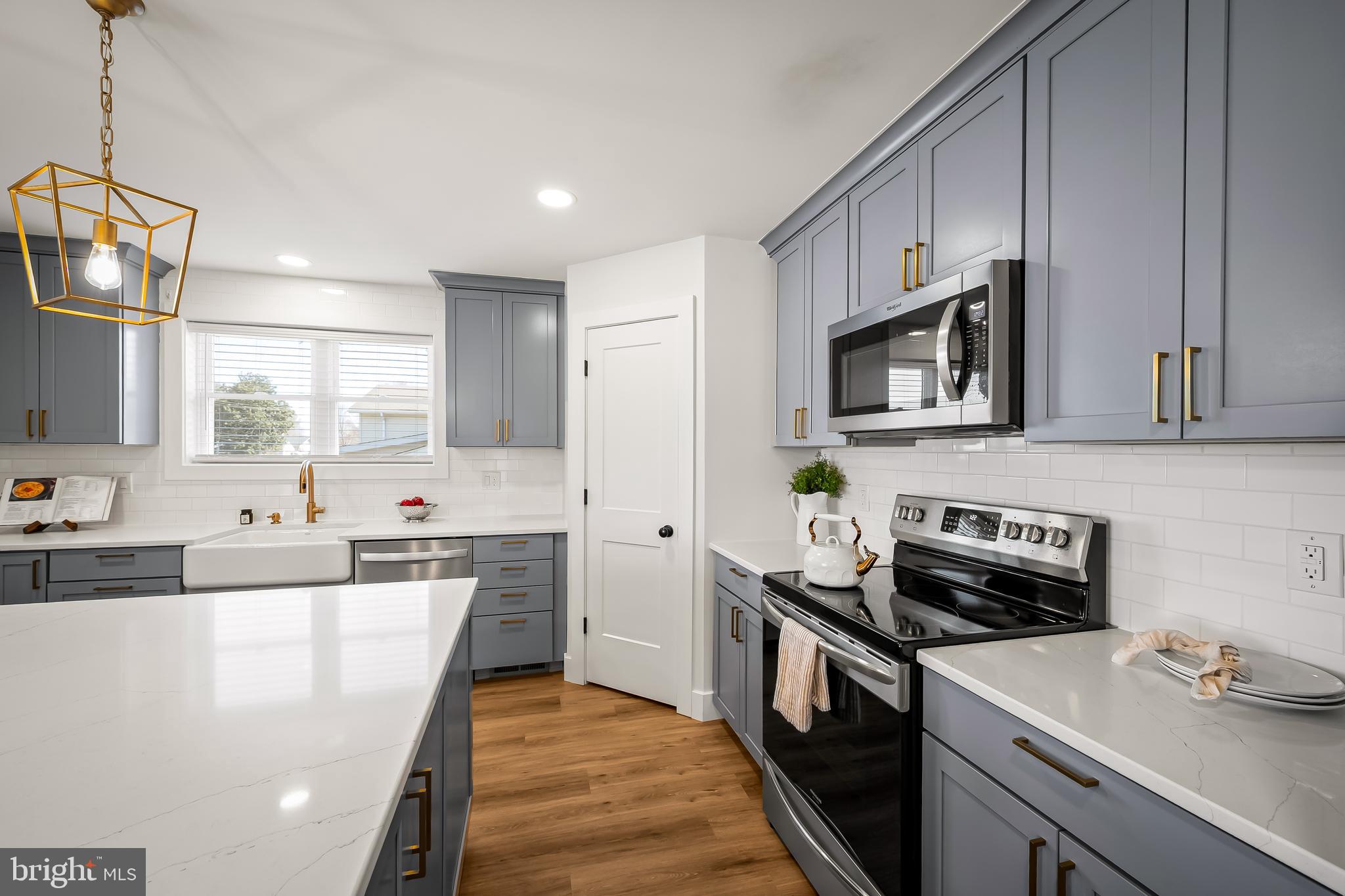 7321 Chesapeake Road Baltimore, MD 21220 - Photo 9 of 60 a kitchen with stainless steel appliances a stove microwave sink refrigerator and cabinets