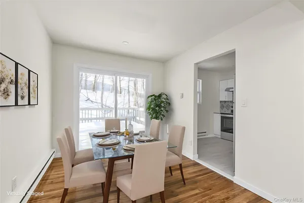 a view of a dining room with furniture and wooden floor