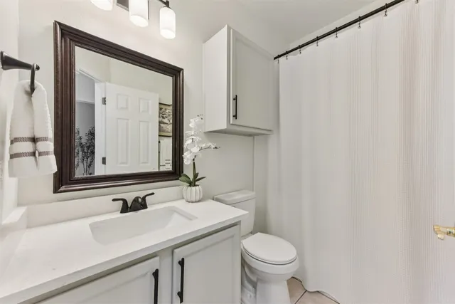 a sign that is sitting in front of flowers