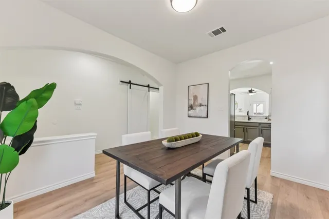 a kitchen with stainless steel appliances granite countertop a refrigerator sink and stove