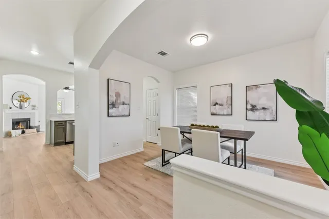 a living room with furniture a clock and a fireplace