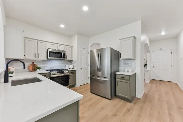 a living room with furniture a fireplace and a window