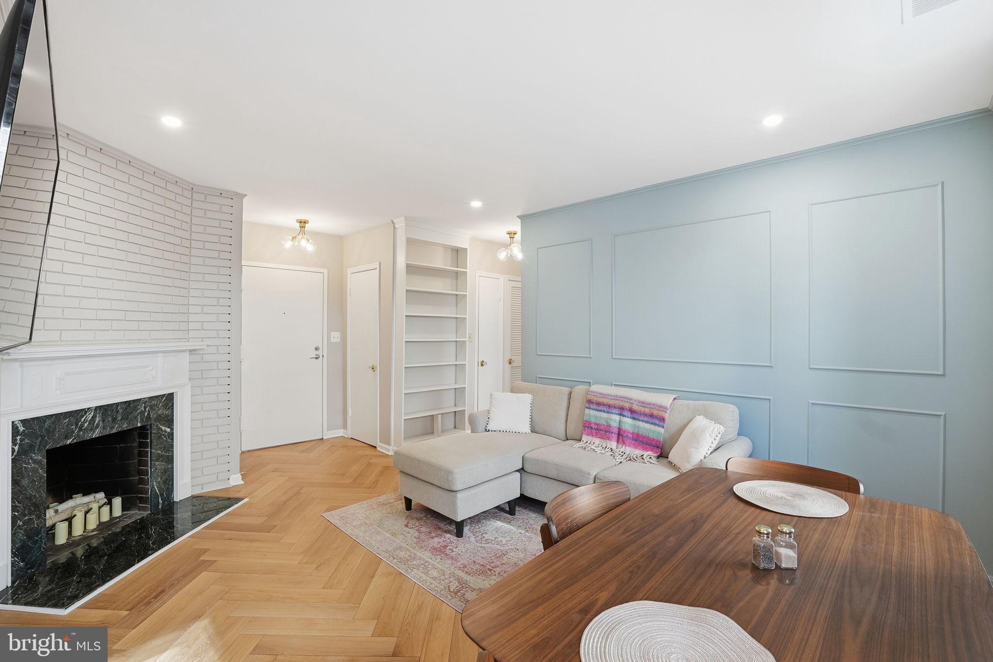 2001 16th Street Northwest, Unit 202 Washington, DC 20009 - Photo 1 of 20 a living room with furniture and a fireplace