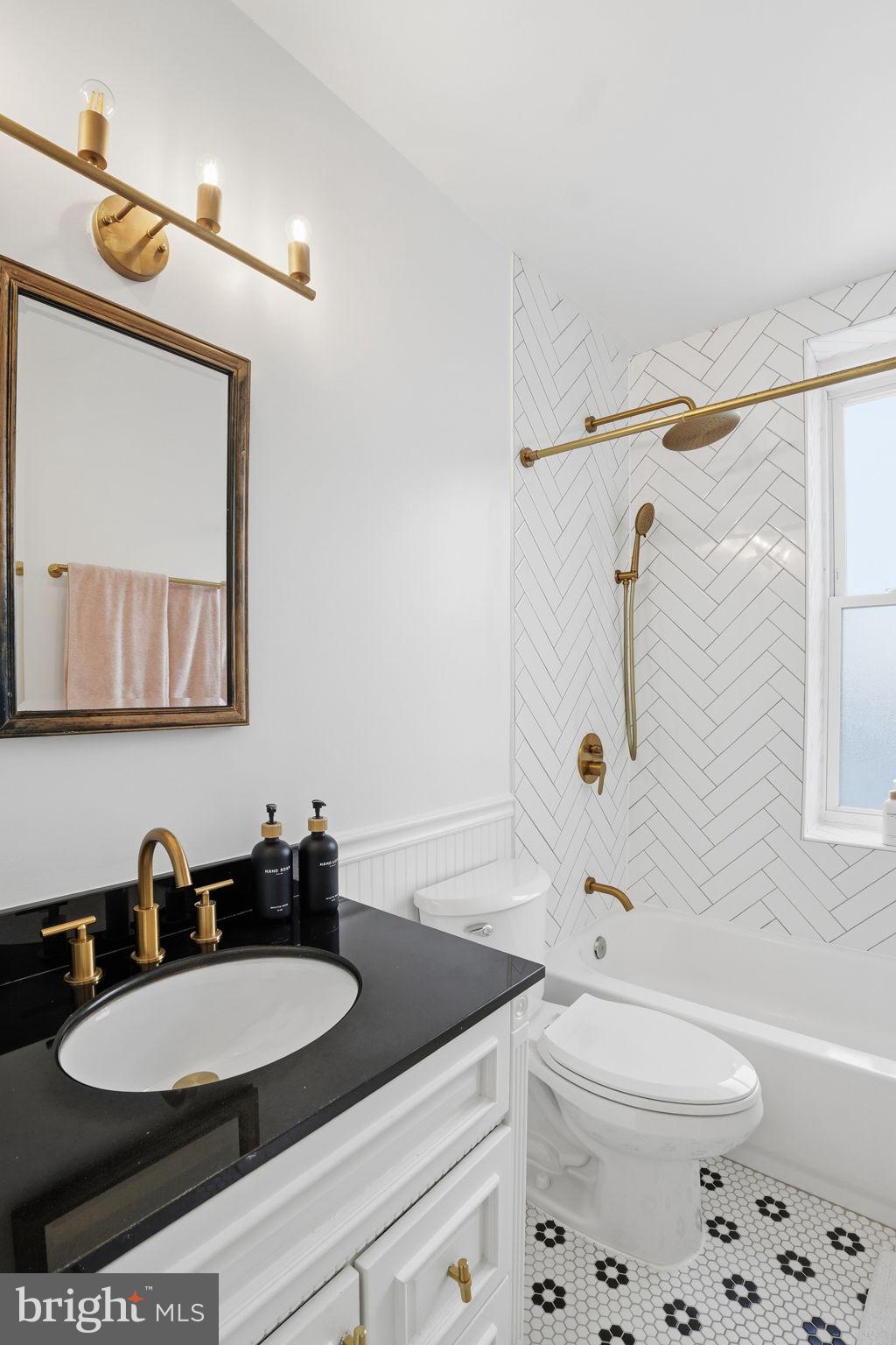 2001 16th Street Northwest, Unit 202 Washington, DC 20009 - Photo 11 of 20 a bathroom with a granite countertop sink mirror vanity and toilet