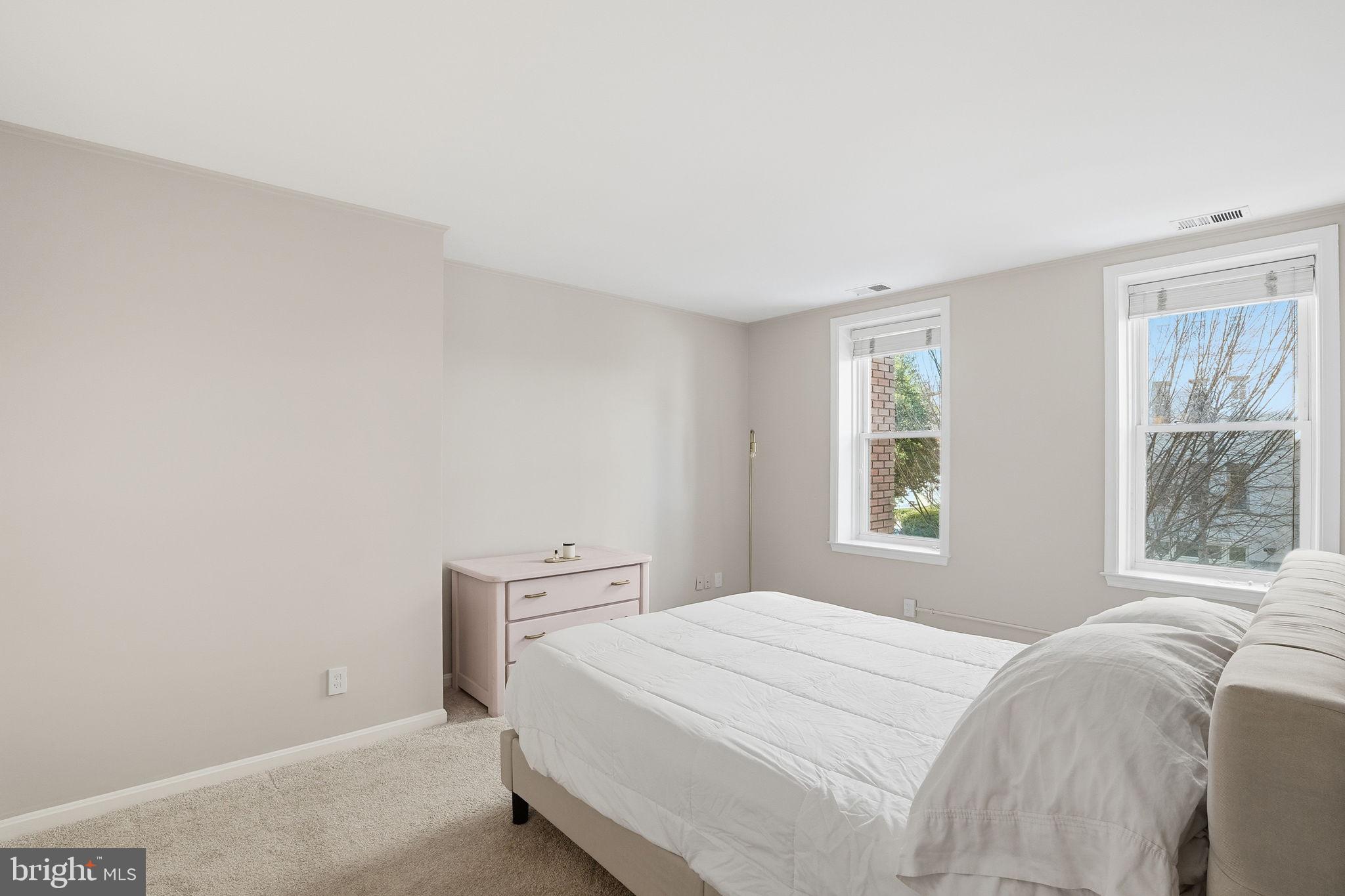 2001 16th Street Northwest, Unit 202 Washington, DC 20009 - Photo 14 of 20 a bedroom with a bed and a window