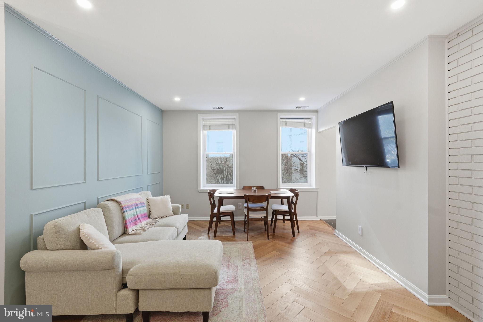 2001 16th Street Northwest, Unit 202 Washington, DC 20009 - Photo 2 of 20 a living room with furniture and a flat screen tv