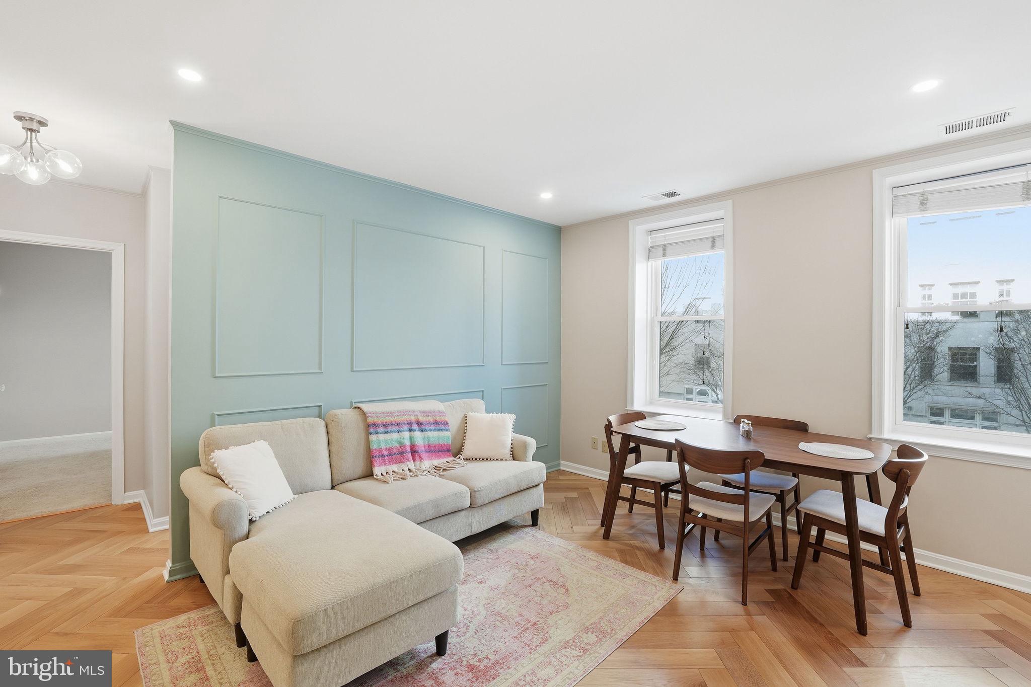 2001 16th Street Northwest, Unit 202 Washington, DC 20009 - Photo 3 of 20 a living room with furniture and a large window