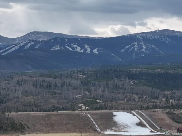 a view of a town with mountains in the background