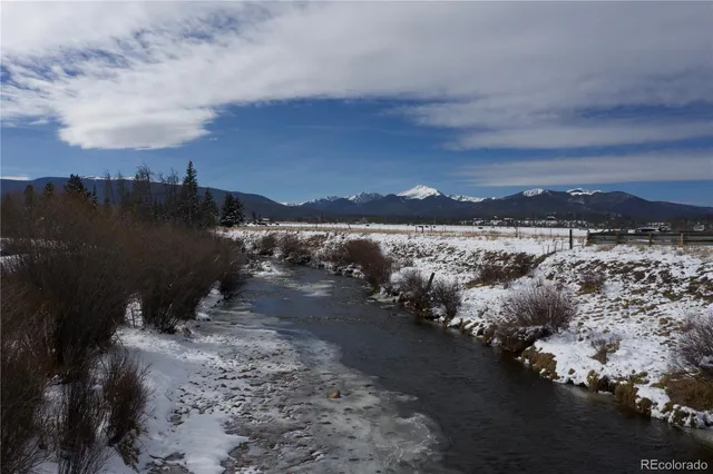 a view of a lake with beach and city