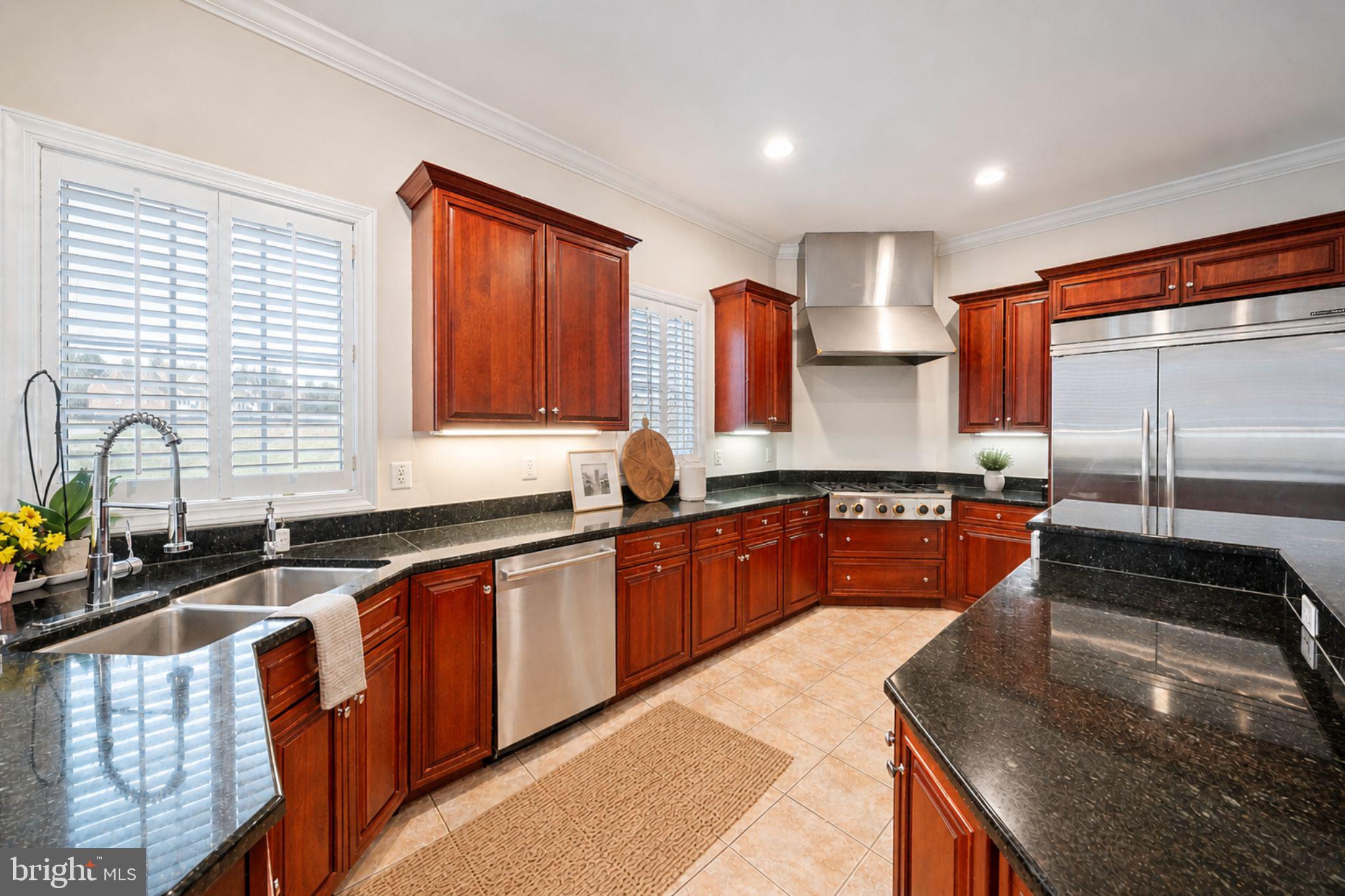 505 Pond View Lane Hunt Valley, MD 21030 - Photo 13 of 104 a kitchen with stainless steel appliances granite countertop wooden cabinets a sink and a stove