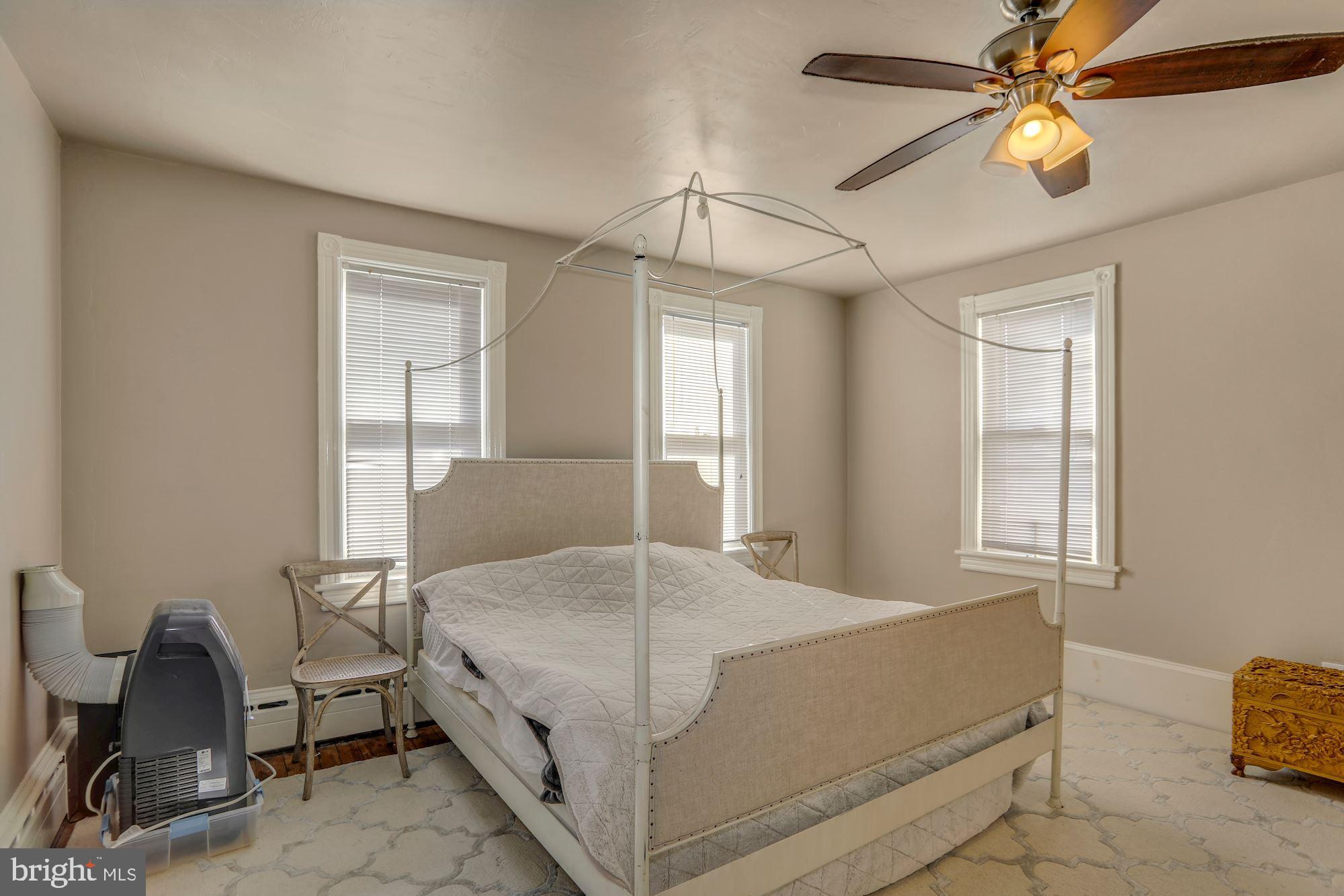 138 Pitman Avenue Pitman, NJ 08071 - Photo 24 of 32 a bedroom with a bed and a chandelier