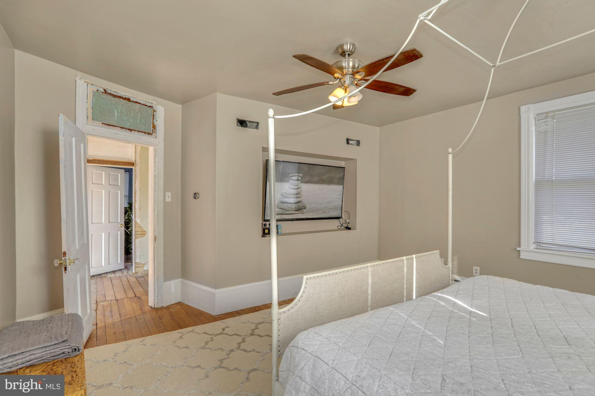 138 Pitman Avenue Pitman, NJ 08071 - Photo 26 of 32 a bedroom with a large bed and a chandelier