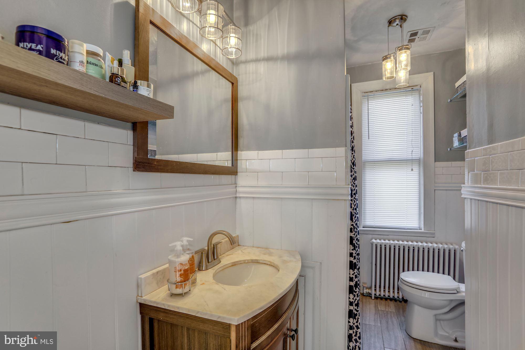 138 Pitman Avenue Pitman, NJ 08071 - Photo 28 of 32 a bathroom with a sink toilet and a mirror