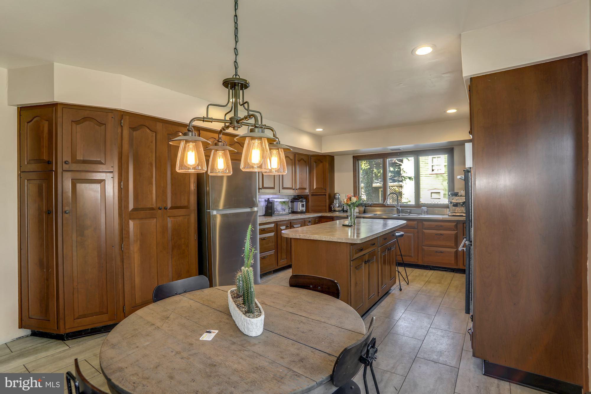 138 Pitman Avenue Pitman, NJ 08071 - Photo 7 of 32 a kitchen with stainless steel appliances granite countertop a refrigerator a stove and a sink with wooden floor