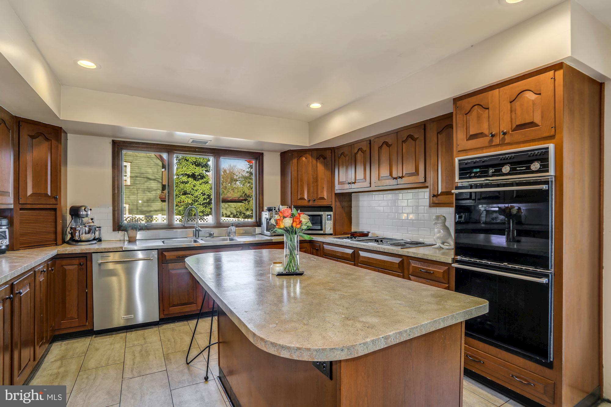138 Pitman Avenue Pitman, NJ 08071 - Photo 9 of 32 a kitchen with stainless steel appliances granite countertop a sink a stove and a refrigerator