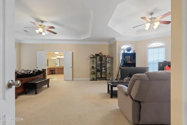 a room with furniture pool table wooden floor and windows