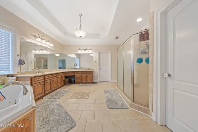 a bedroom with furniture and flat tv screen on the dresser