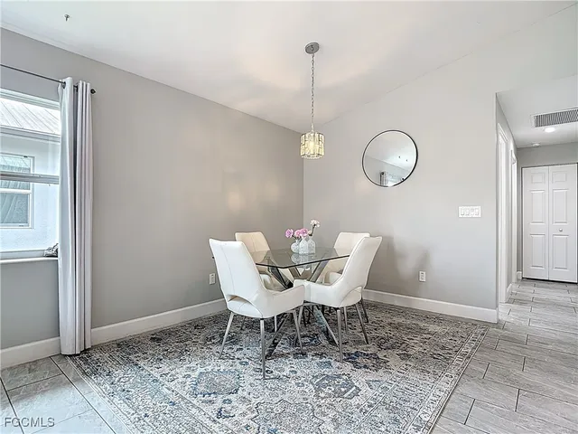 a dining room with a table and chairs