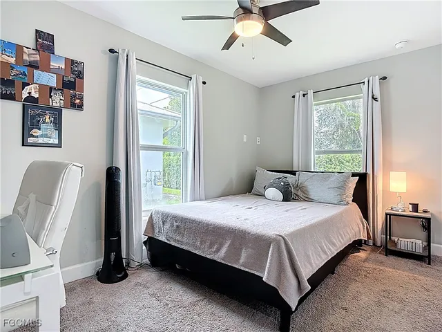 a bedroom with a bed wooden floor and window